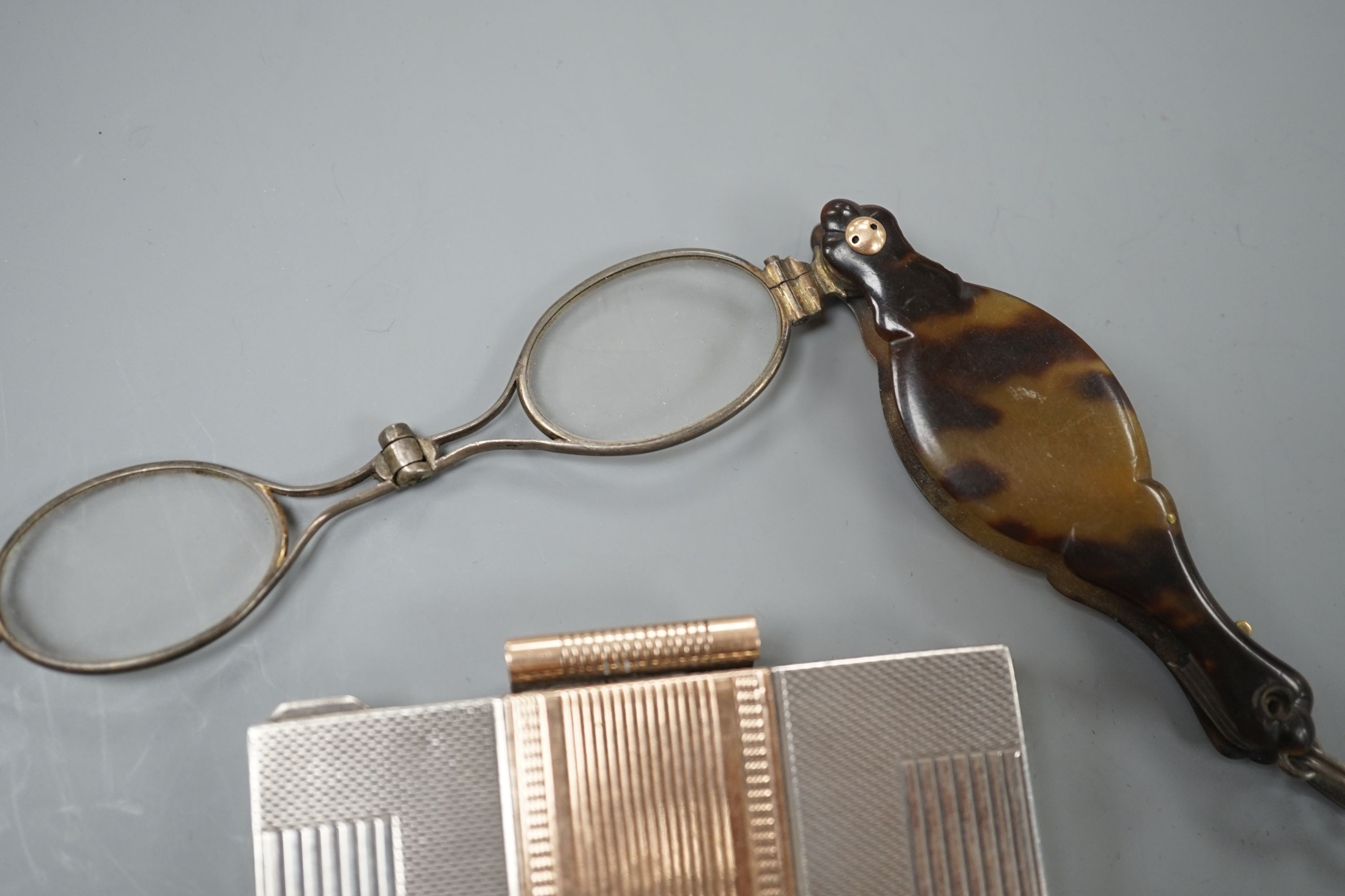 A white and yellow metal (stamped silver 9ct) compact and a pair of tortoiseshell mounted spectacles.